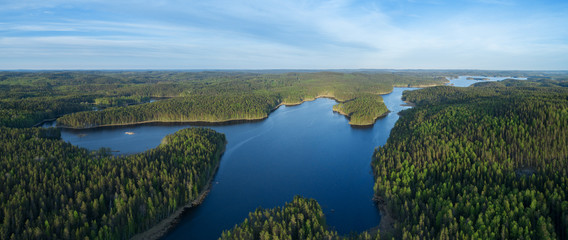 Aerial drone view of blue lakes and green forests. Beautiful summer panorama. National park in Finland.