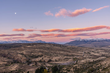 Colorful and vibrant sunset against snowcapped mountains