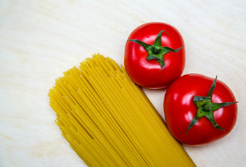 spaghetti and red tomatoes on the open background