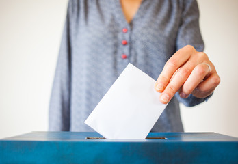 elections - The hand of woman putting her vote in the ballot box