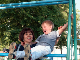 Obraz premium boy 6 years old sitting on the bar.