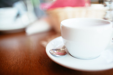 White mug of tea on a dark wooden table