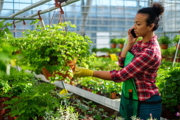 Black woman working in a botanical garden