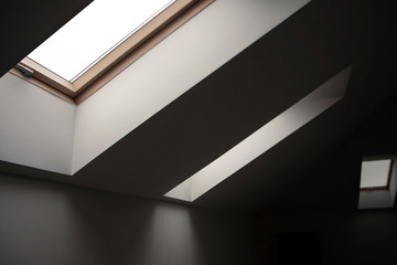 Windows in the attic. Architectural elements.Contrasting geometric interior details, white walls,...