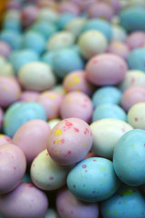 Fototapeta na wymiar Small colorful chocolate eggs in hard sugar shell in bulk for Easter