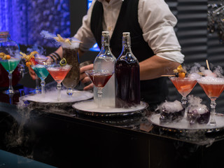the bartender mixes a cocktail