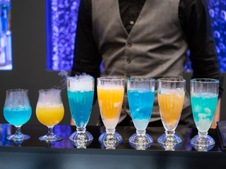 cocktails in glass cups on a tray