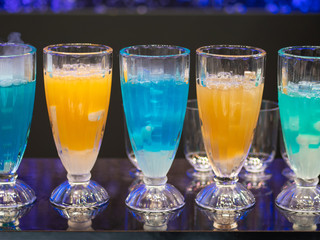 cocktails in glass cups on a tray