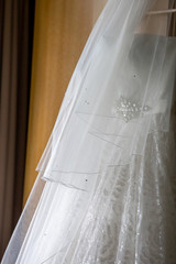 Bridal dress hanging at wooden closet