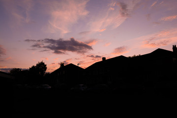 Row of houses in sunset on suburban street