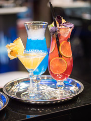 cocktails in glass cups on a tray