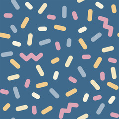 seamless pattern of colored sprinkles and zig-zags in vector