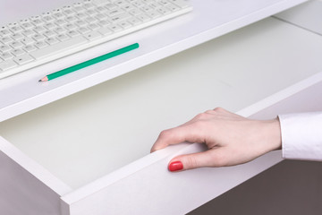 Open shelf, female hand, pencil, keyboard, top view, background, copy space