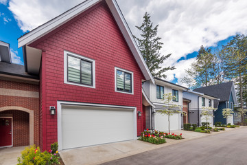 Beautiful exterior of newly built luxury home. Yard with green grass and landscape.