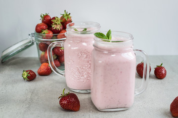 Fresh organic sugar free strawberry smoothie or milkshake on the table. Healthy dessert concept.