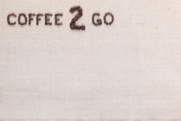 Coffee to go inscription from seeds, arranged top left