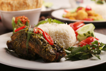 fried chicken wrapped in green chili served with rice