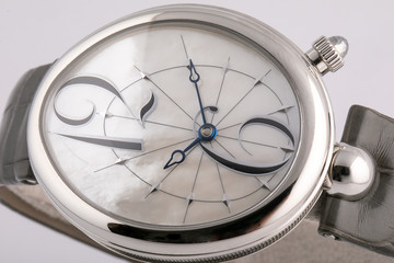 Female silver watch with a grey dial, blue clockwise, with a black leather strap.