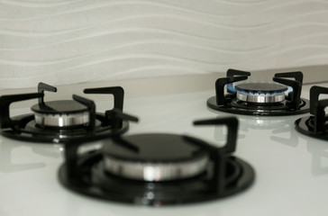 Gas burners with blue flame on modern stove