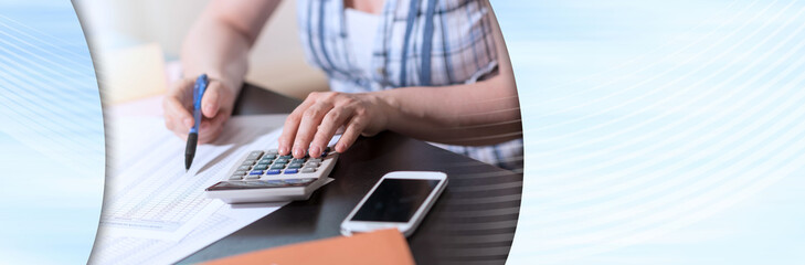 Female accountant using calculator; panoramic banner