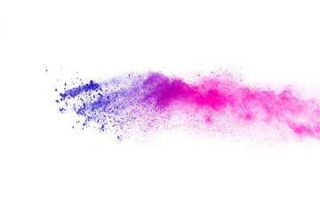 Freeze motion of purple color powder exploding on white background.