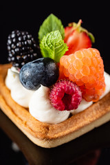 Fresh Fruit Tart with berries isolated on black background