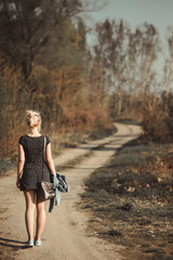 Young woman walking on dirt road