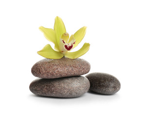 Fototapeta na wymiar Spa stones with beautiful orchid flower on white background