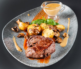 beef steak with sauce and baked potatoes