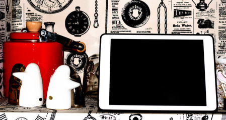 Classic penguin ceramic and vintage teapot with modern gadget on display