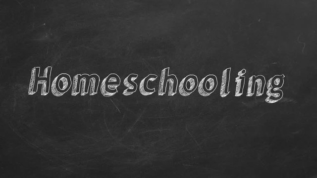 Hand drawing "Homeschooling" on black chalkboard. Stop motion animation.