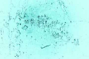 Vintage azure background. Rough painted wall of turquoise color. Imperfect plane of cyan colored. Uneven old decorative toned backdrop of aqzure tint. Texture of teal hue. Ornamental stony surface.