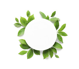 Blank card and spring green leaves on white background, top view. Space for text
