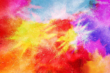 Freeze motion of colorful color powder exploding on white background.  Paint Holi.