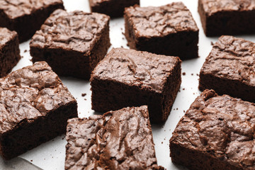 Fresh brownies on parchment paper. Delicious chocolate pie
