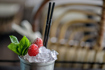 cocktail with ice and raspberry