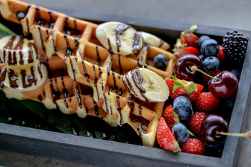 Belgian waffles in chocolate with fruit