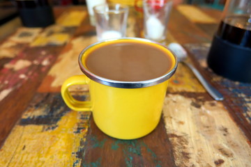 Indonesian coffee in yellow metallic coffee-mug