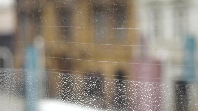 Cleaning windows horizontally with a window sweeper squeegee and gloves close up