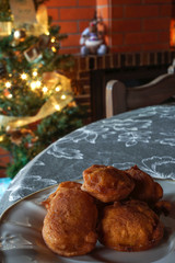 Plate with bilharaco, a traditional Portuguese pastry and sweet. Blurry background with Christmas lights and decorations