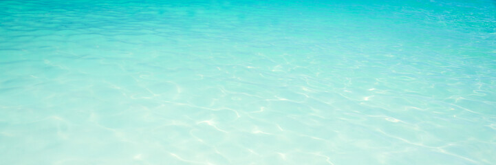 Blue turquoise translucent water ocean panoramic background, pristine water in a tropical lagoon,...