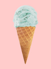 mint chocolate chip ice cream in the cone isolated on pink