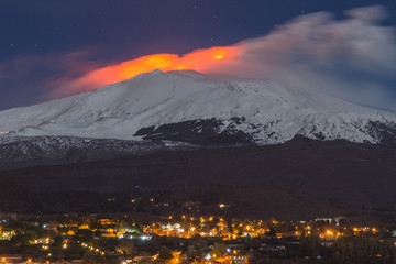 etna during an eruption over the city