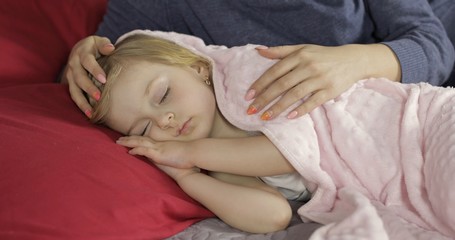 Fototapeta na wymiar Cute baby sleeping on the bed at home. Little girl sleeping in morning light