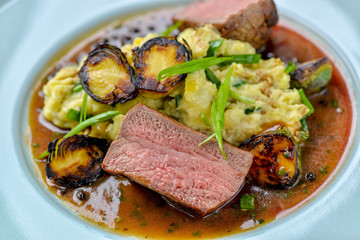 meat with vegetables and sauce in a beautiful serve