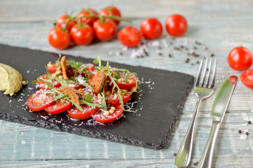 tomato salad with green sauce and herbs