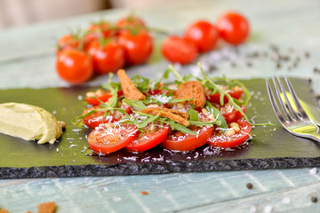 tomato salad with green sauce and herbs