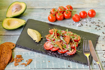 tomato salad with green sauce and herbs