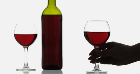 Rose wine. Red wine in wine glass over white background