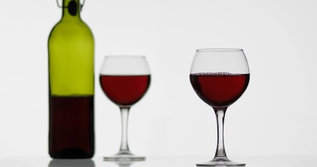 Rose wine. Red wine in wine glass over white background